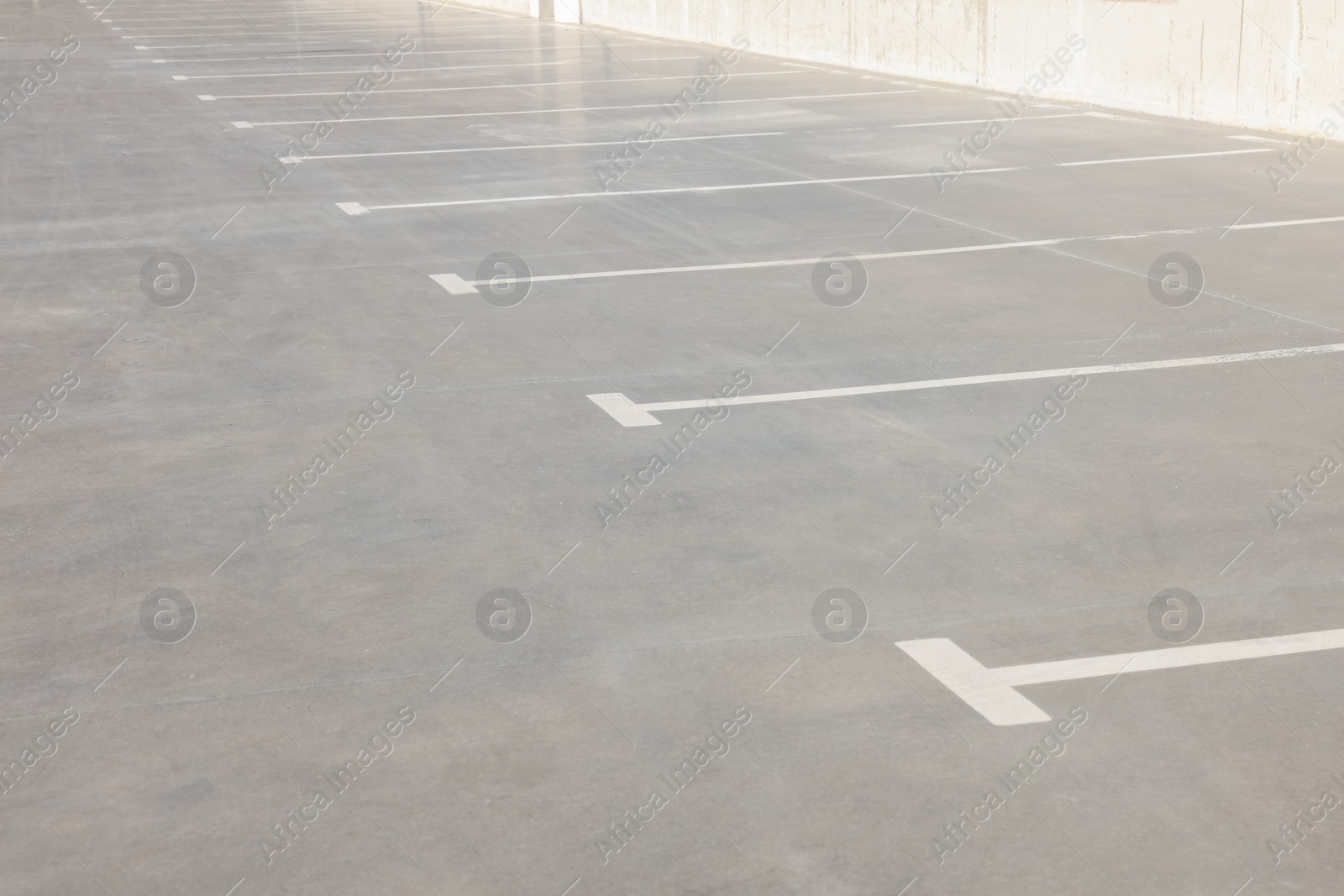 Photo of Outdoor car parking lot with white marking lines 