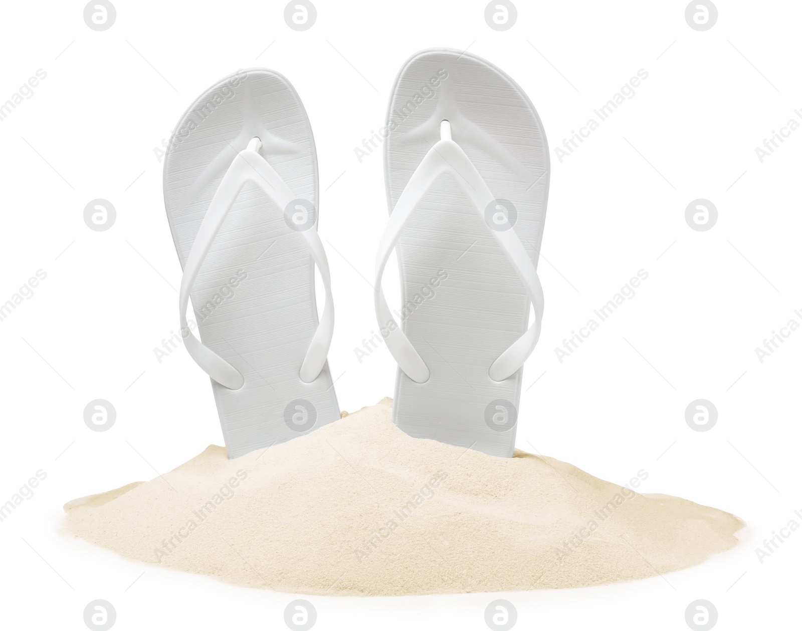 Photo of Bright flip flops in sand on white background