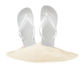 Bright flip flops in sand on white background
