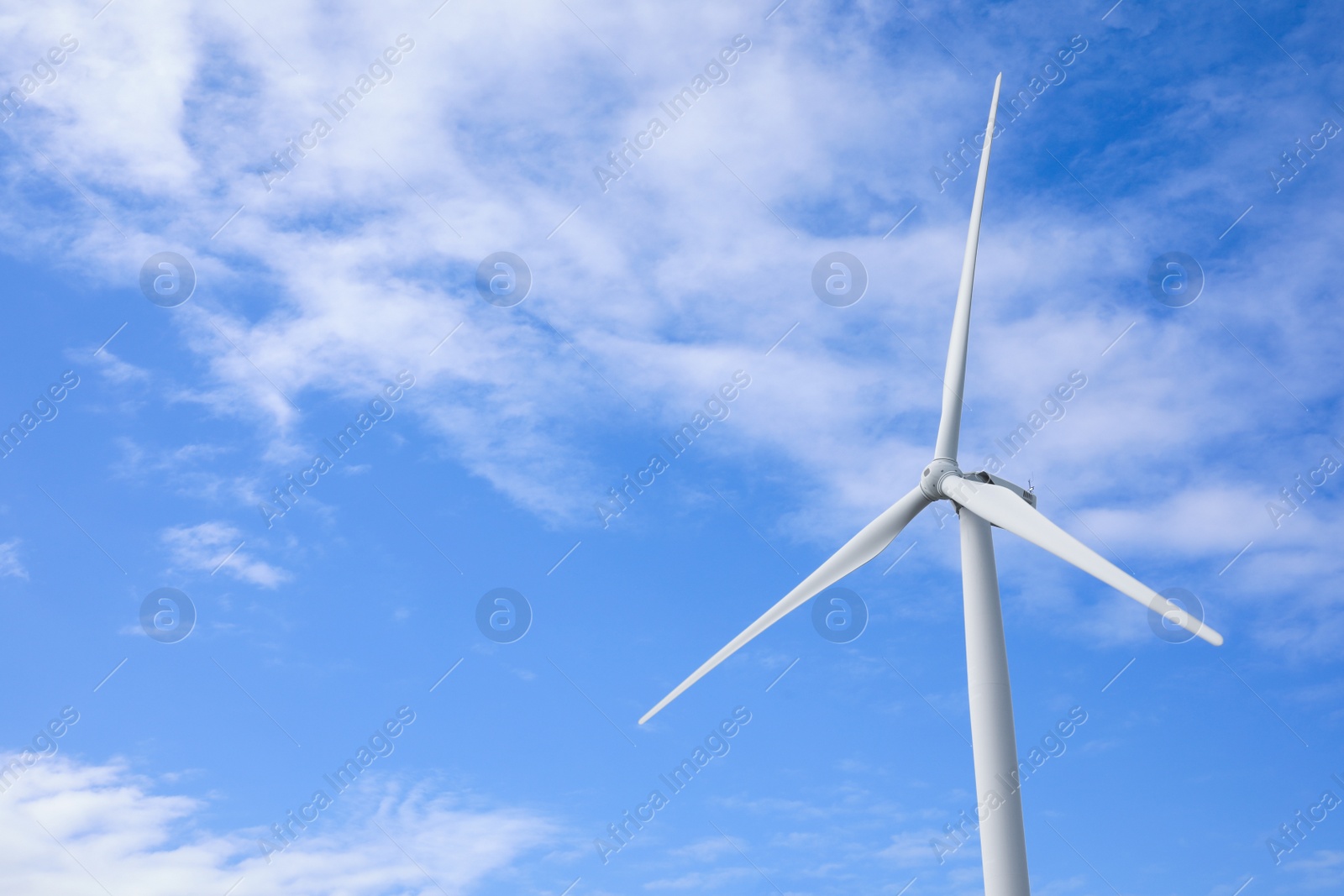 Photo of Wind turbine against beautiful blue sky. Alternative energy source