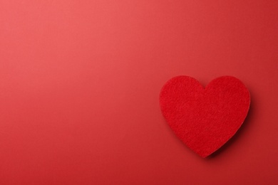 Photo of Decorative heart on red background, top view. Space for text