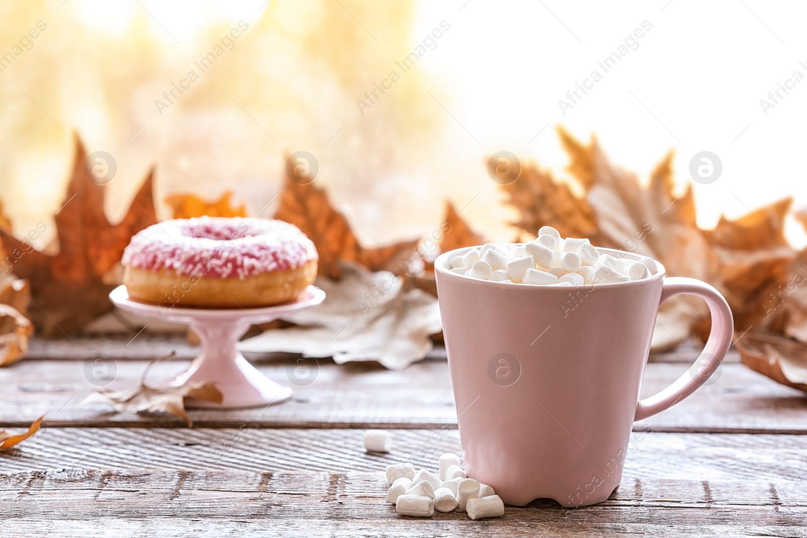 Photo of Composition with cup of hot cozy drink and autumn leaves on windowsill. Space for text