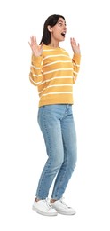 Surprised woman in jeans and sweater on white background