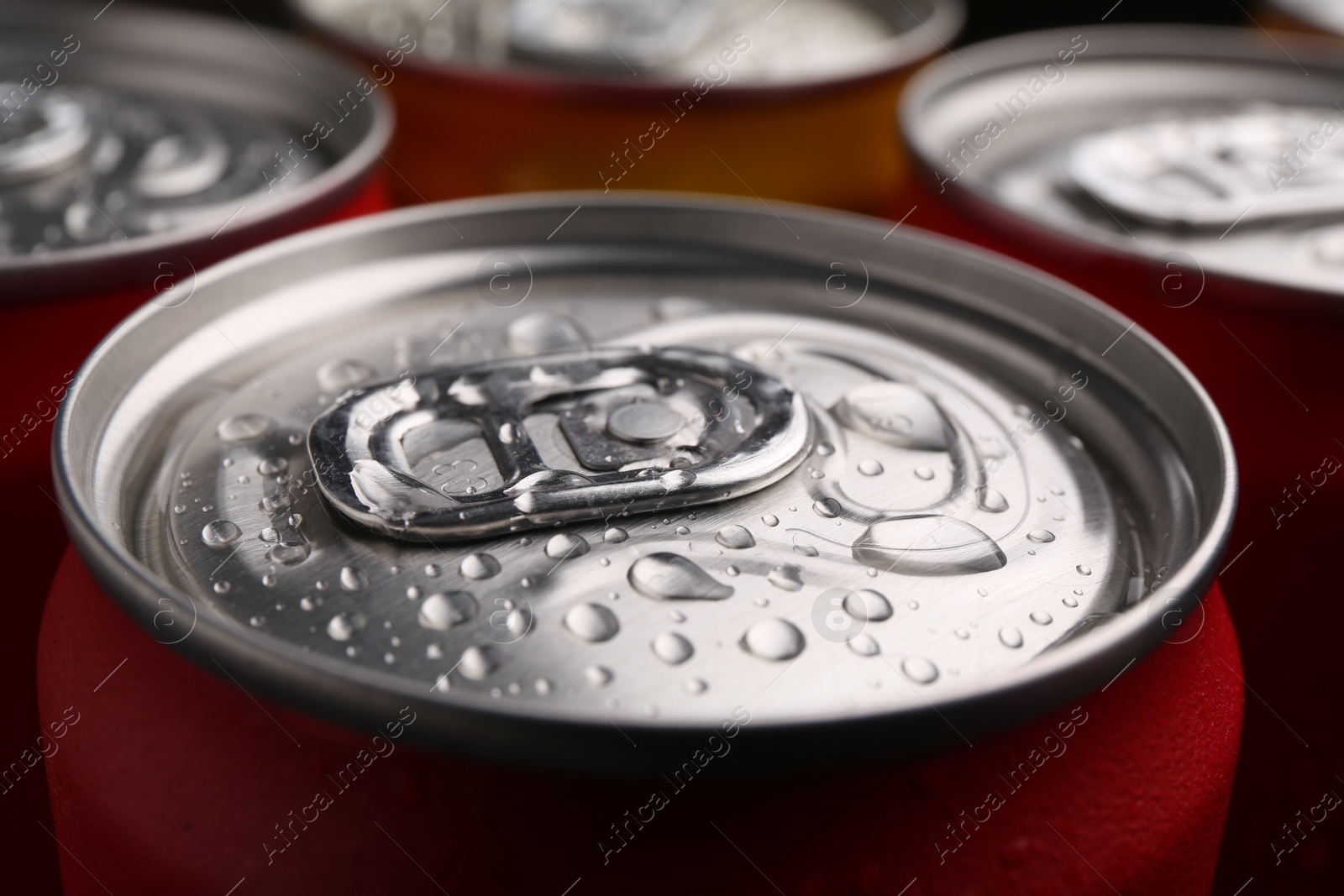 Photo of Energy drinks in wet cans, closeup. Functional beverage