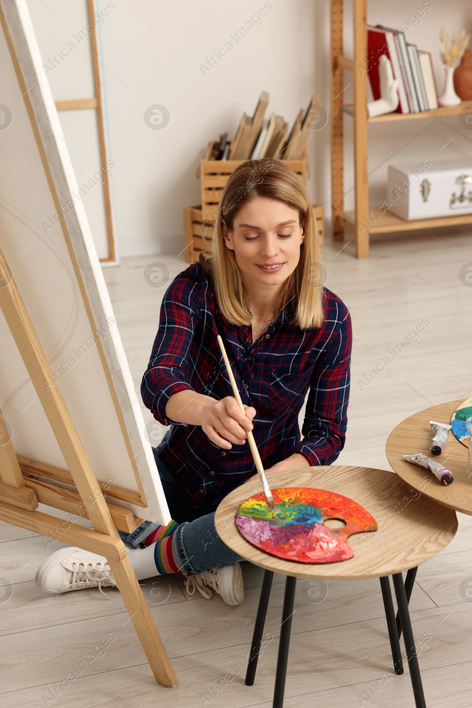 Photo of Beautiful woman painting in studio. Creative hobby