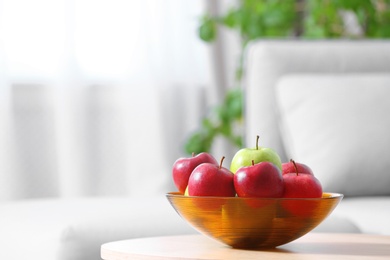 Photo of Bowl of fresh apples on table indoors. Space for text