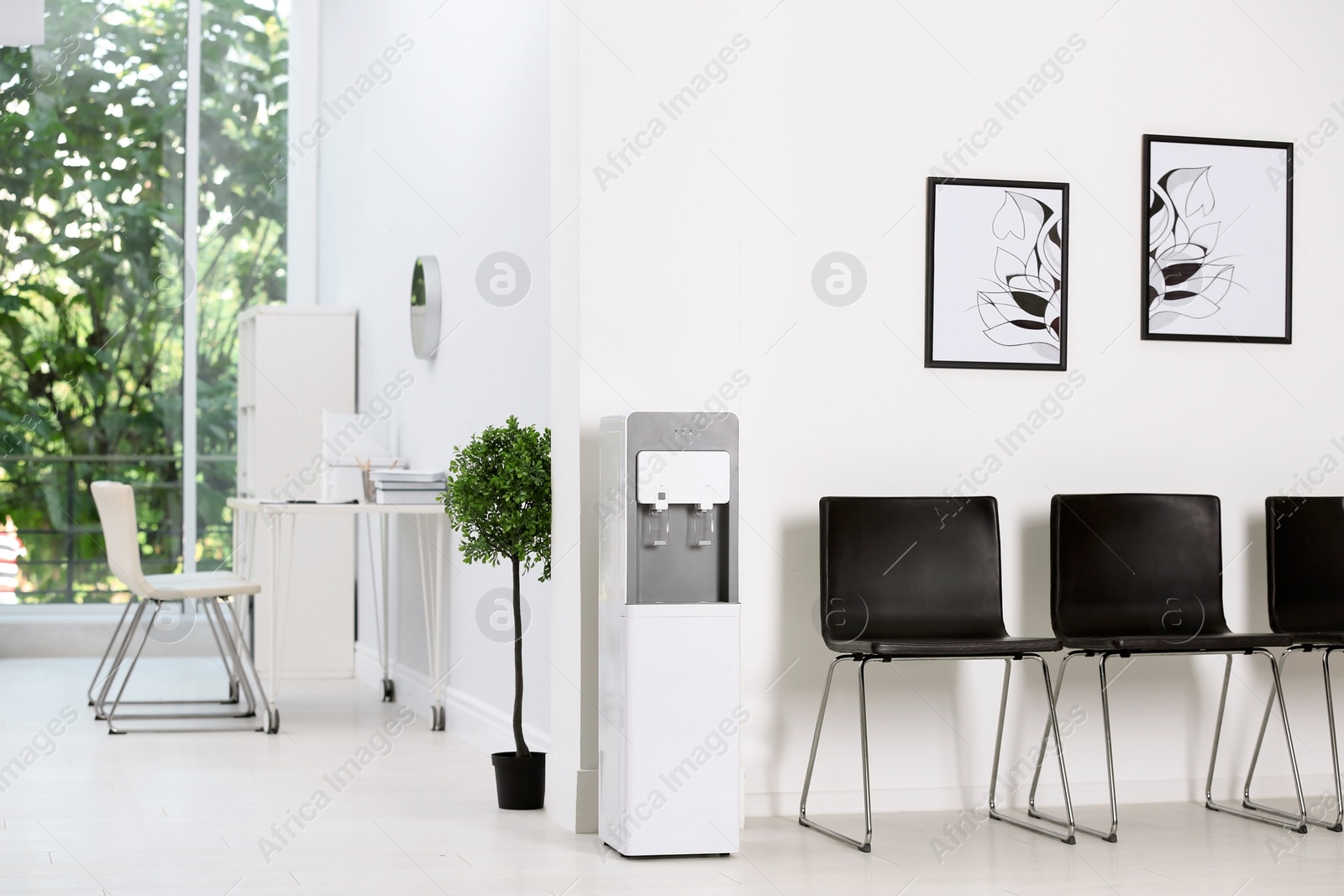 Photo of Modern water cooler in stylish office interior