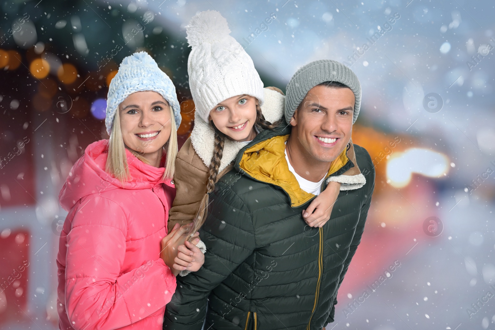 Image of Happy family at Christmas fair. Bokeh effect