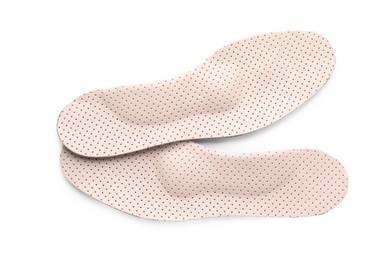 Beige orthopedic insoles isolated on white, top view