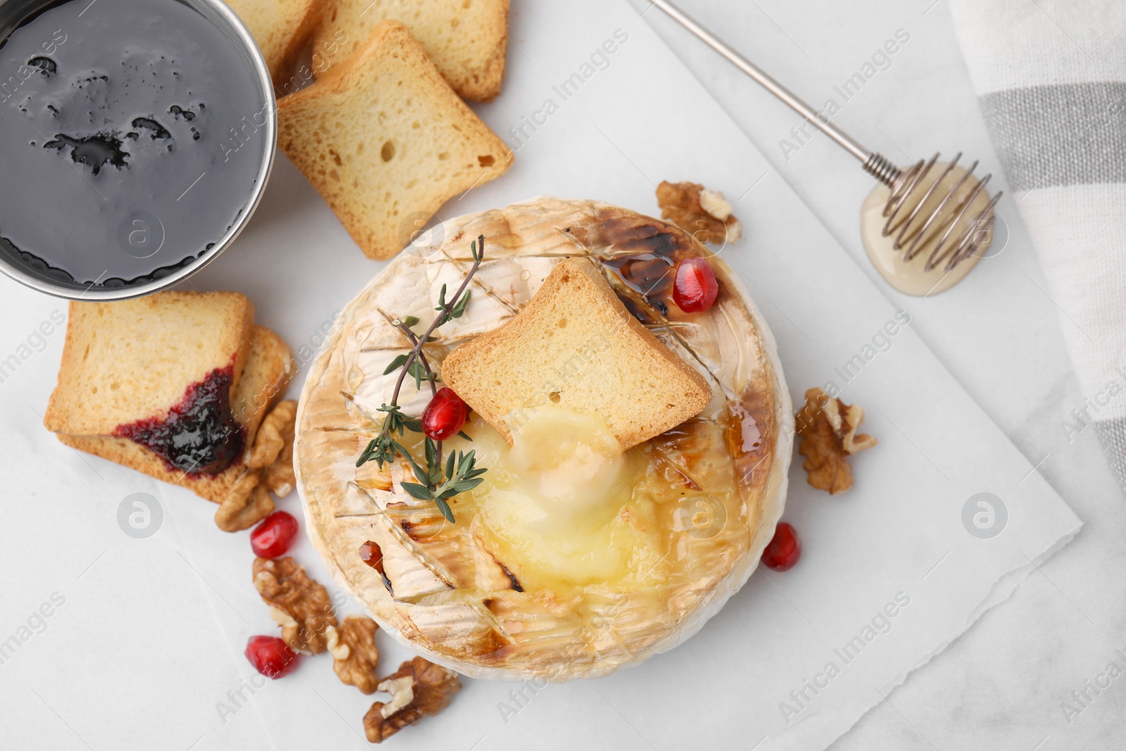 Photo of Flat lay composition with tasty baked camembert on white marble table