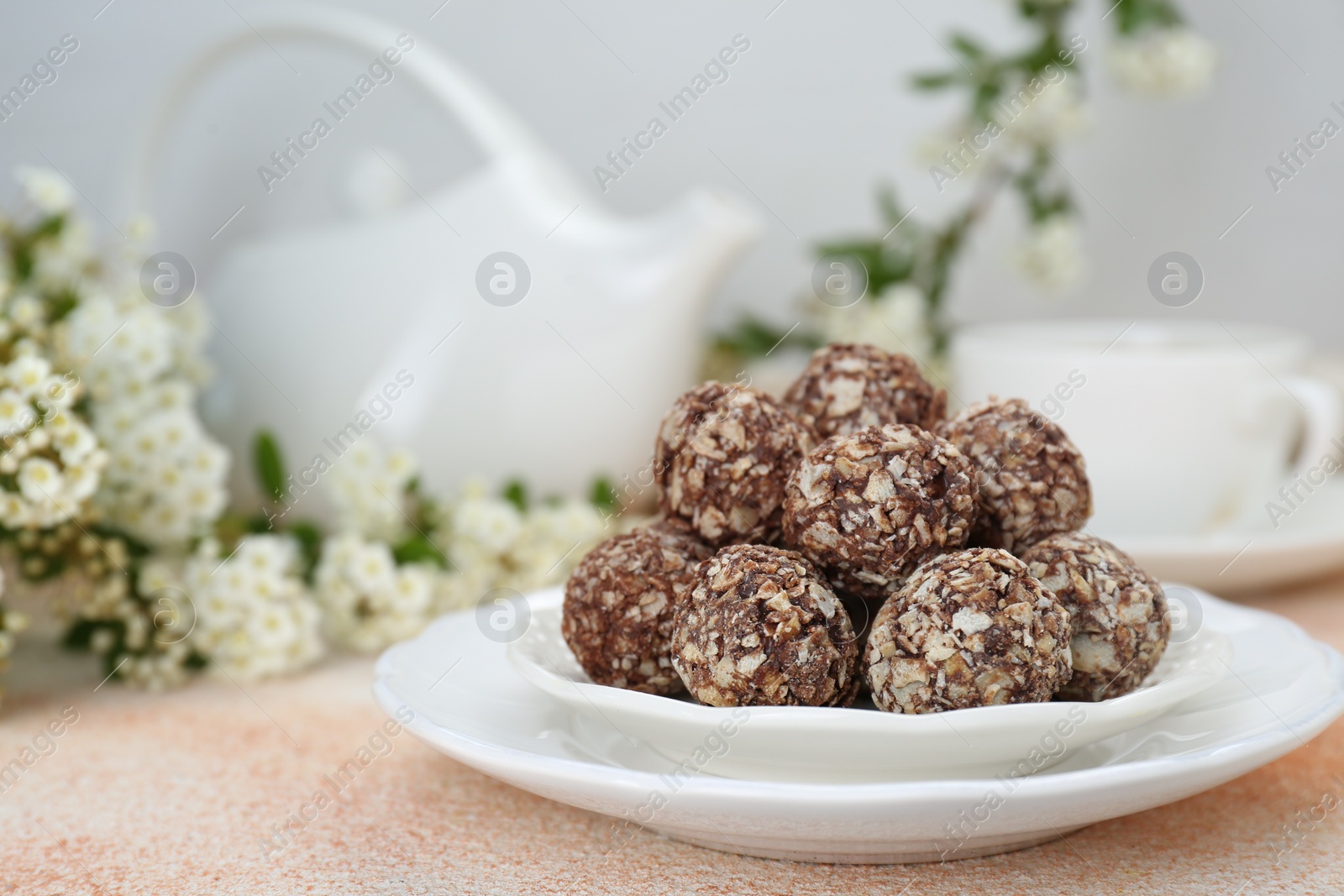 Photo of Delicious sweet chocolate candies on beige table