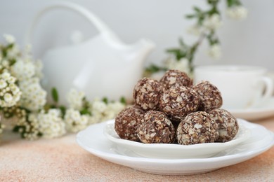 Delicious sweet chocolate candies on beige table