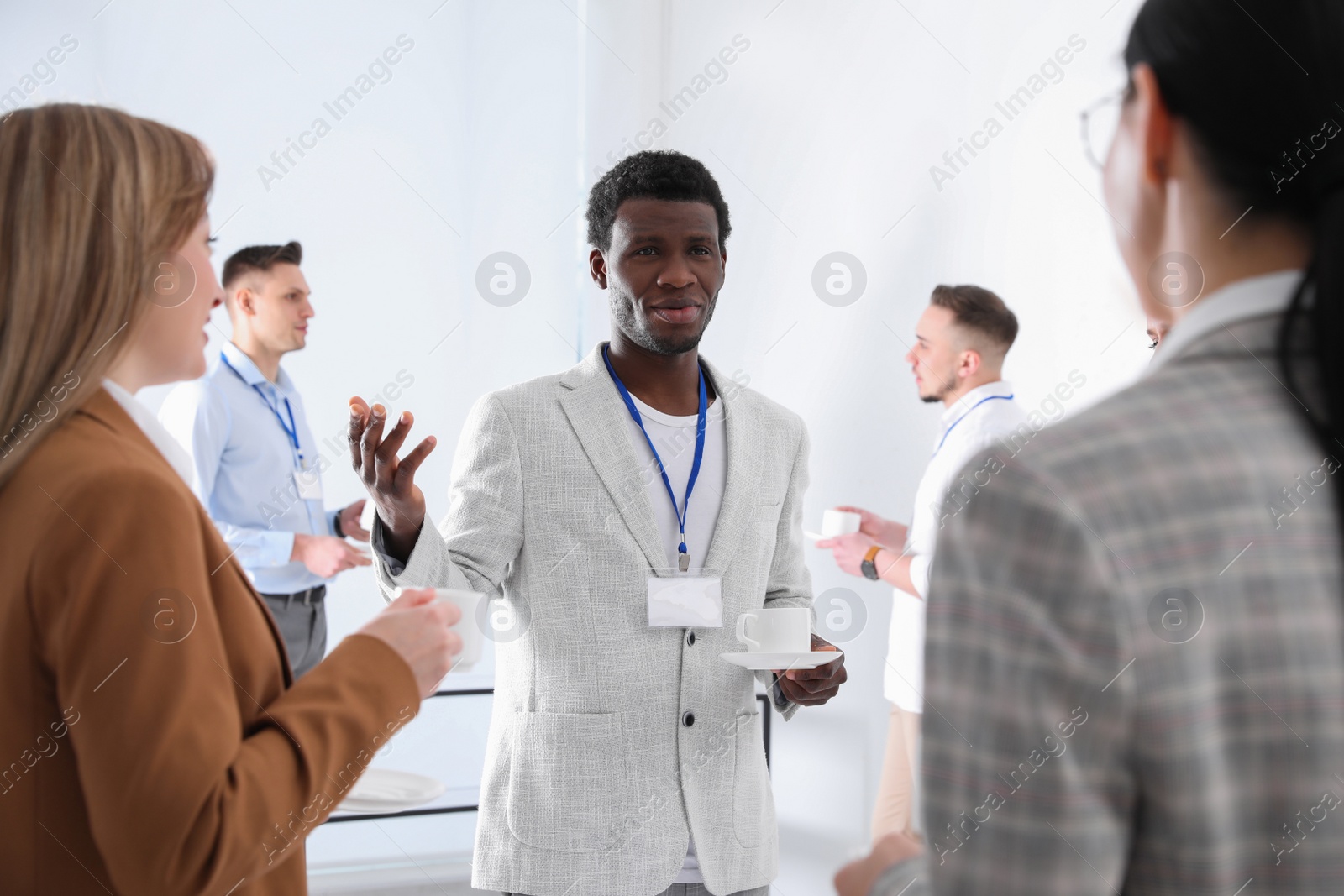 Photo of Group of people chatting during coffee break indoors