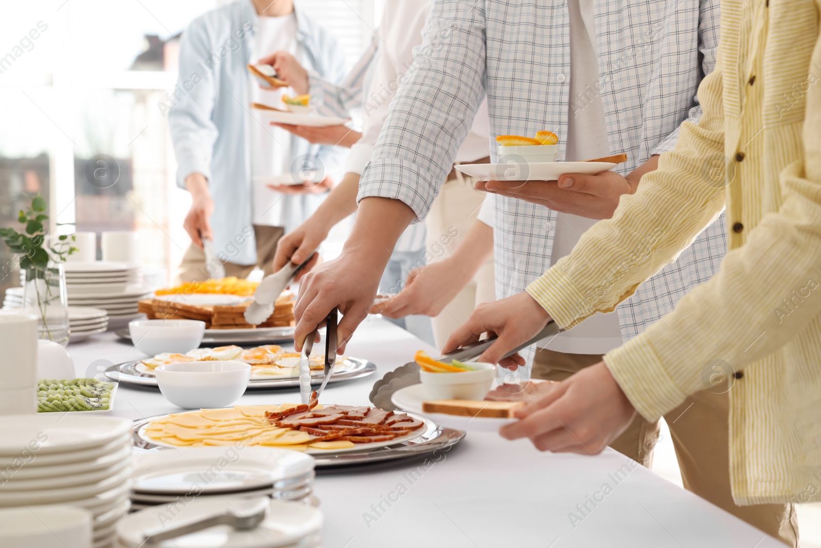 Photo of People taking food during breakfast, closeup. Buffet service