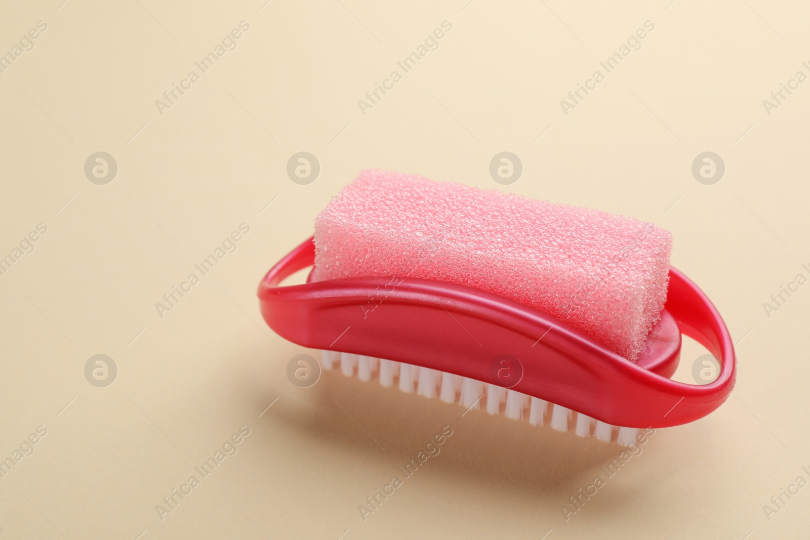 Photo of Pedicure tool with pumice stone and brush on beige background
