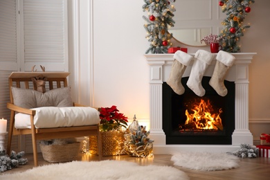 Photo of Fireplace with Christmas stockings in beautifully decorated living room