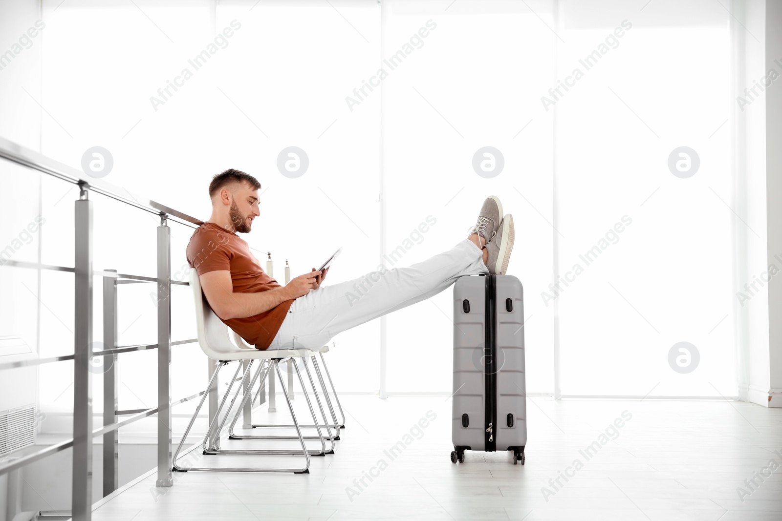 Photo of Young man with suitcase in airport