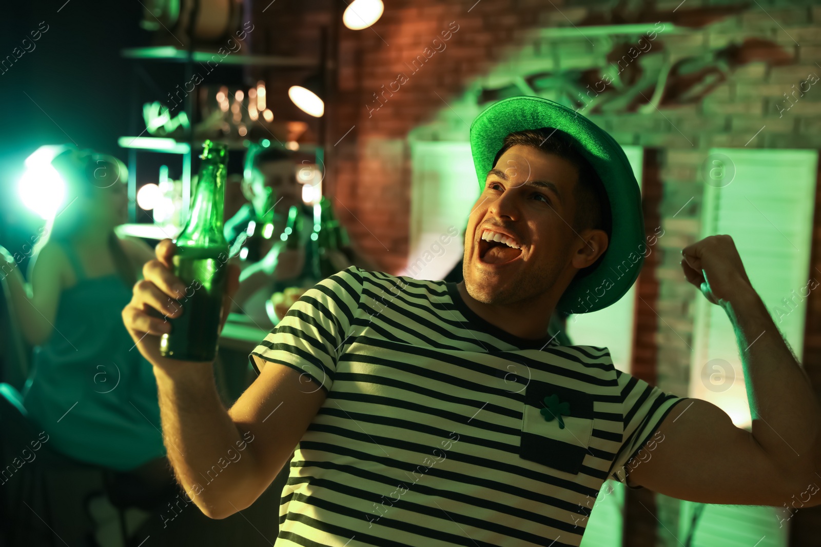 Photo of Man with beer celebrating St Patrick's day in pub