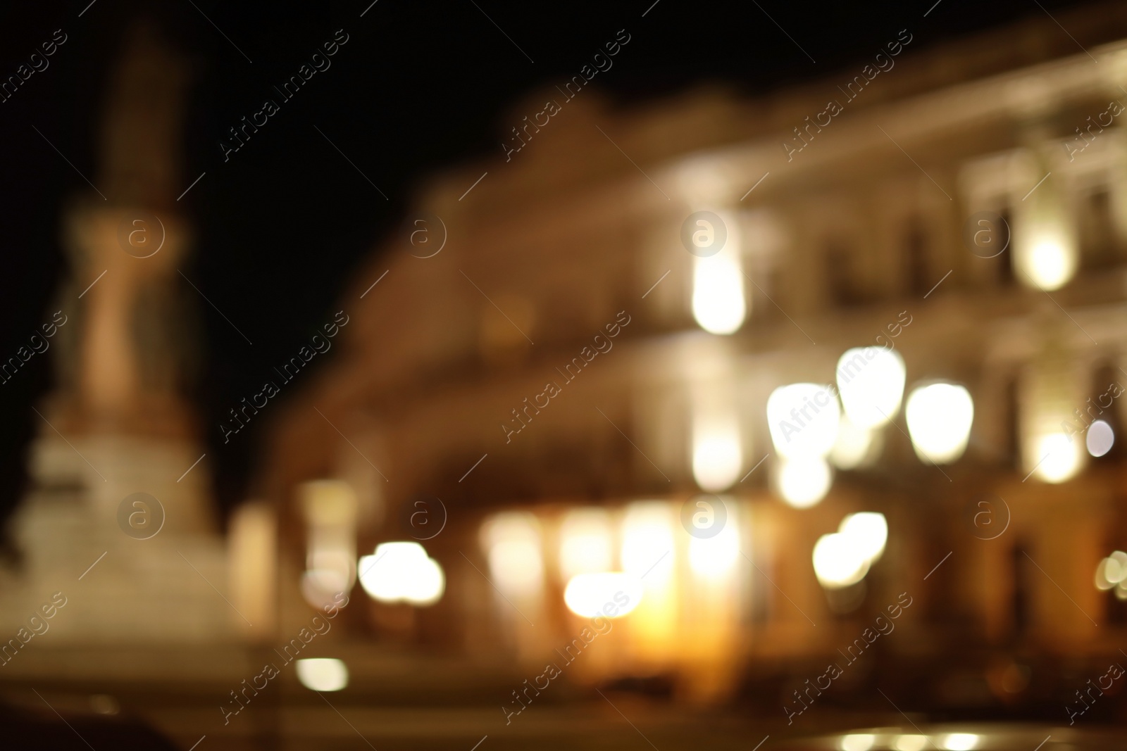 Photo of Blurred view of street with lights at night. Bokeh effect