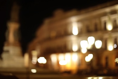 Photo of Blurred view of street with lights at night. Bokeh effect