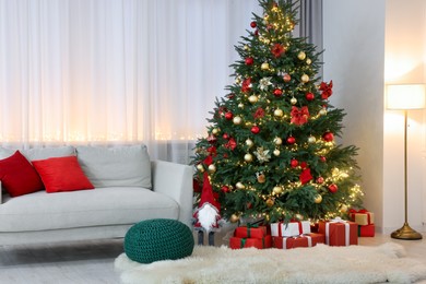 Photo of Beautiful Christmas tree, gift boxes and festive decor in living room. Interior design