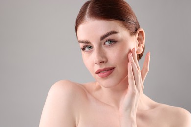 Photo of Portrait of beautiful woman on grey background