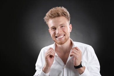 Photo of Portrait of handsome young man on dark background