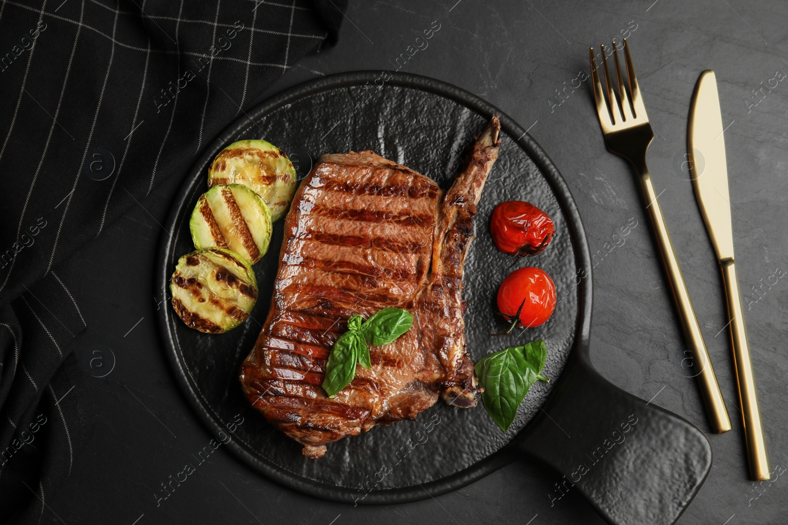 Photo of Flat lay composition with grilled meat steak on black table