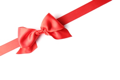 Photo of Red ribbon with bow on white background. Festive decoration