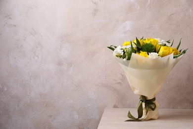 Photo of Beautiful bouquet with peony tulips on wooden table. Space for text