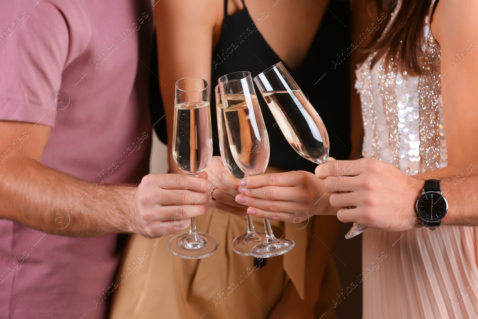 Photo of Friends clinking glasses with champagne, closeup. Party time