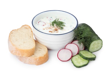 Photo of Delicious cold summer soup, bread and ingredients  on white background