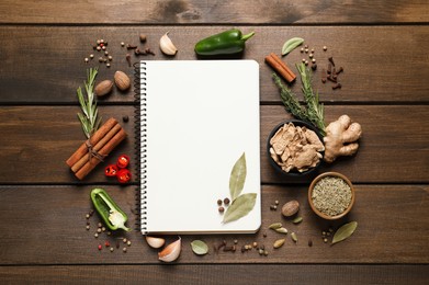 Blank recipe book and different ingredients on wooden table, flat lay. Space for text