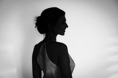 Image of Silhouette of woman on white background, profile portrait