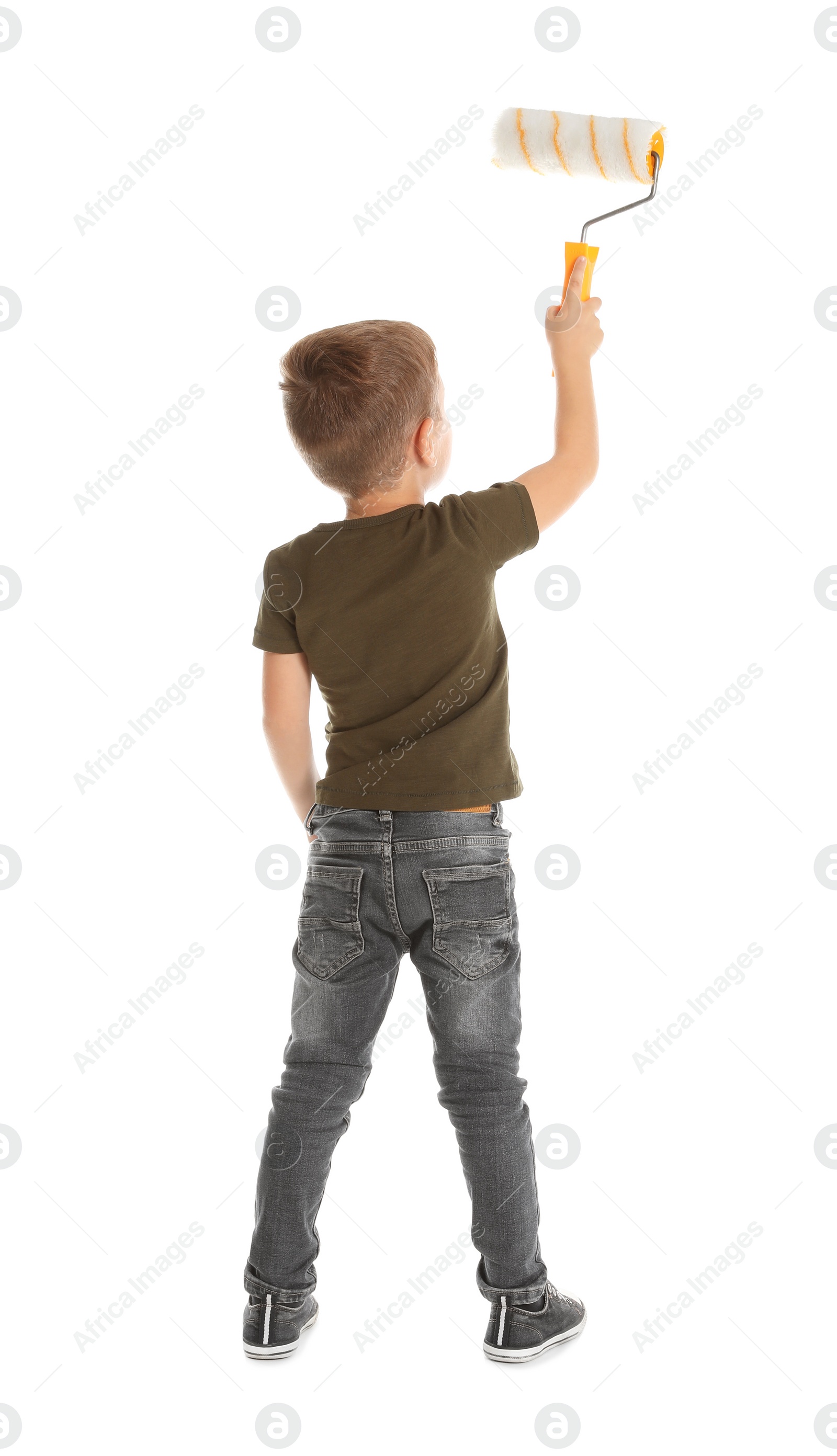 Photo of Little child painting something with roller brush on white background