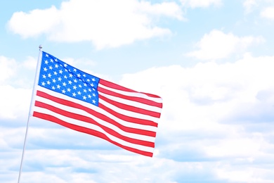 Photo of Woman with American flag outdoors on cloudy day. Space for text