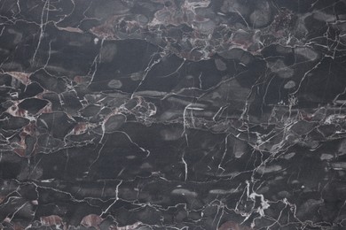 Photo of Dark grey marble surface as background, closeup