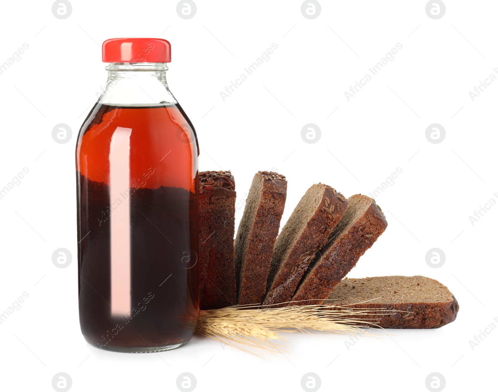 Photo of Bottle of delicious fresh kvass, spikelets and bread on white background