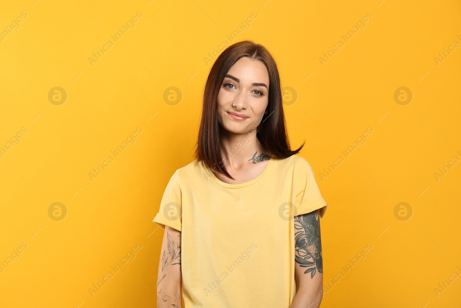 Photo of Portrait of pretty young woman with gorgeous chestnut hair on yellow background