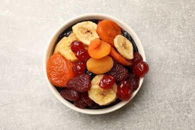 Photo of Mix of delicious dried fruits on grey table, top view