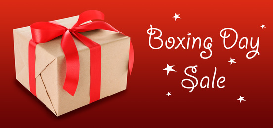 Image of Boxing day sale. Gift on red background, banner design
