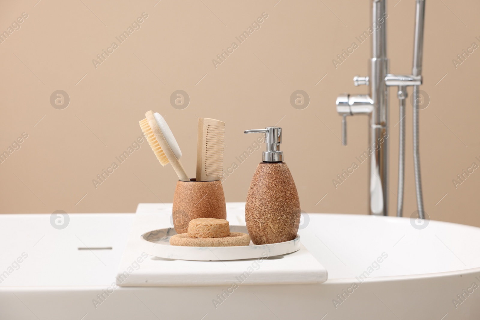 Photo of Different personal care products and accessories on bath tub in bathroom