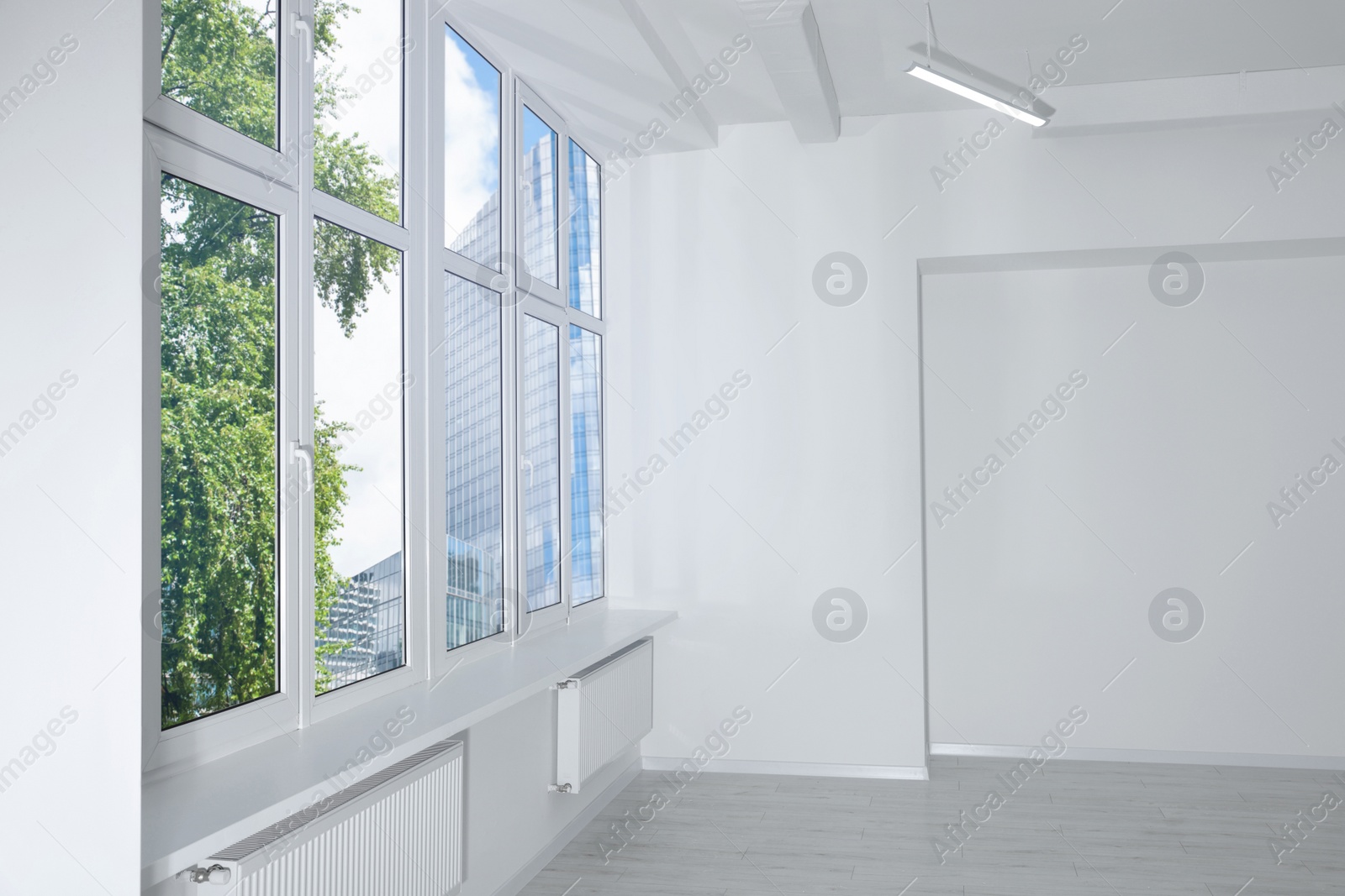 Photo of New empty room with clean windows and white walls