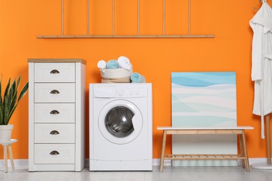 Stylish laundry room with washing machine. Interior design