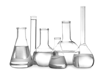 Photo of Glassware with liquids isolated on white. Laboratory analysis