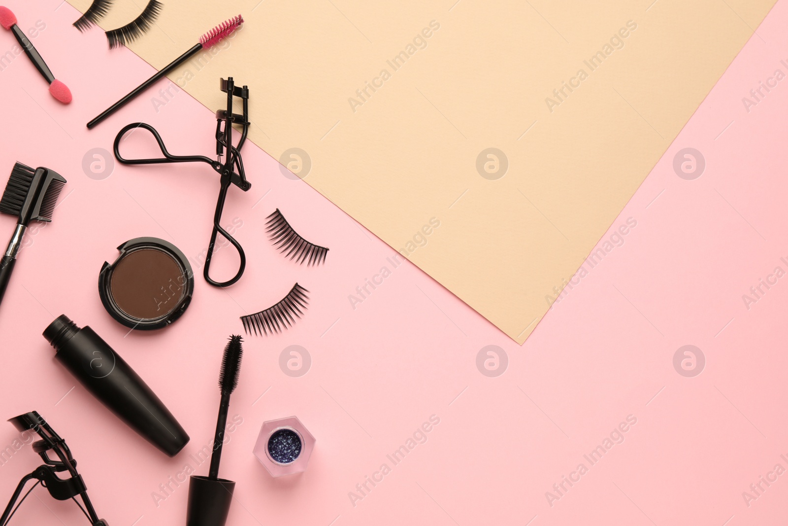 Photo of Flat lay composition with eyelash curler, makeup products and accessories on color background. Space for text