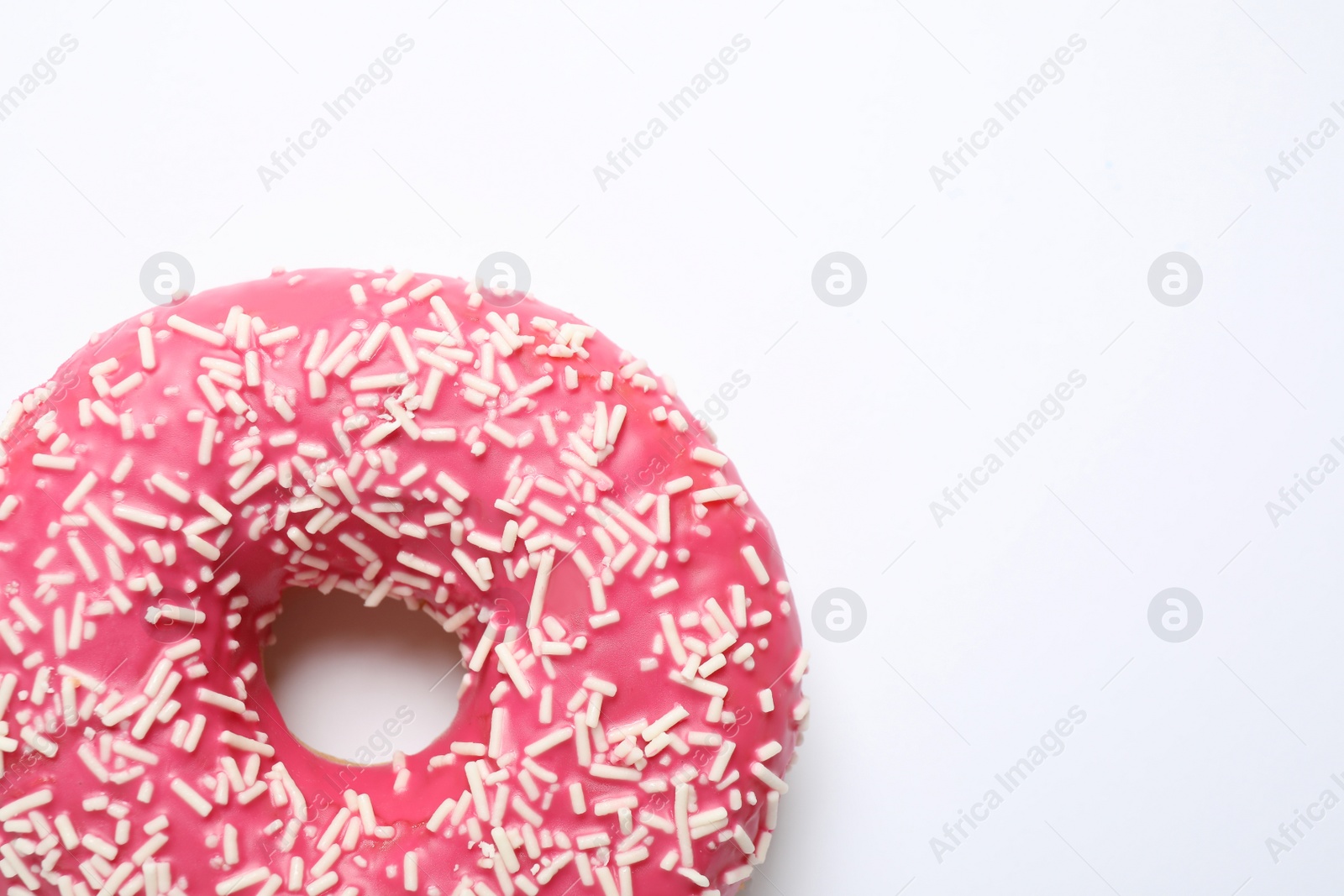 Photo of Delicious glazed donut on white background, top view. Space for text