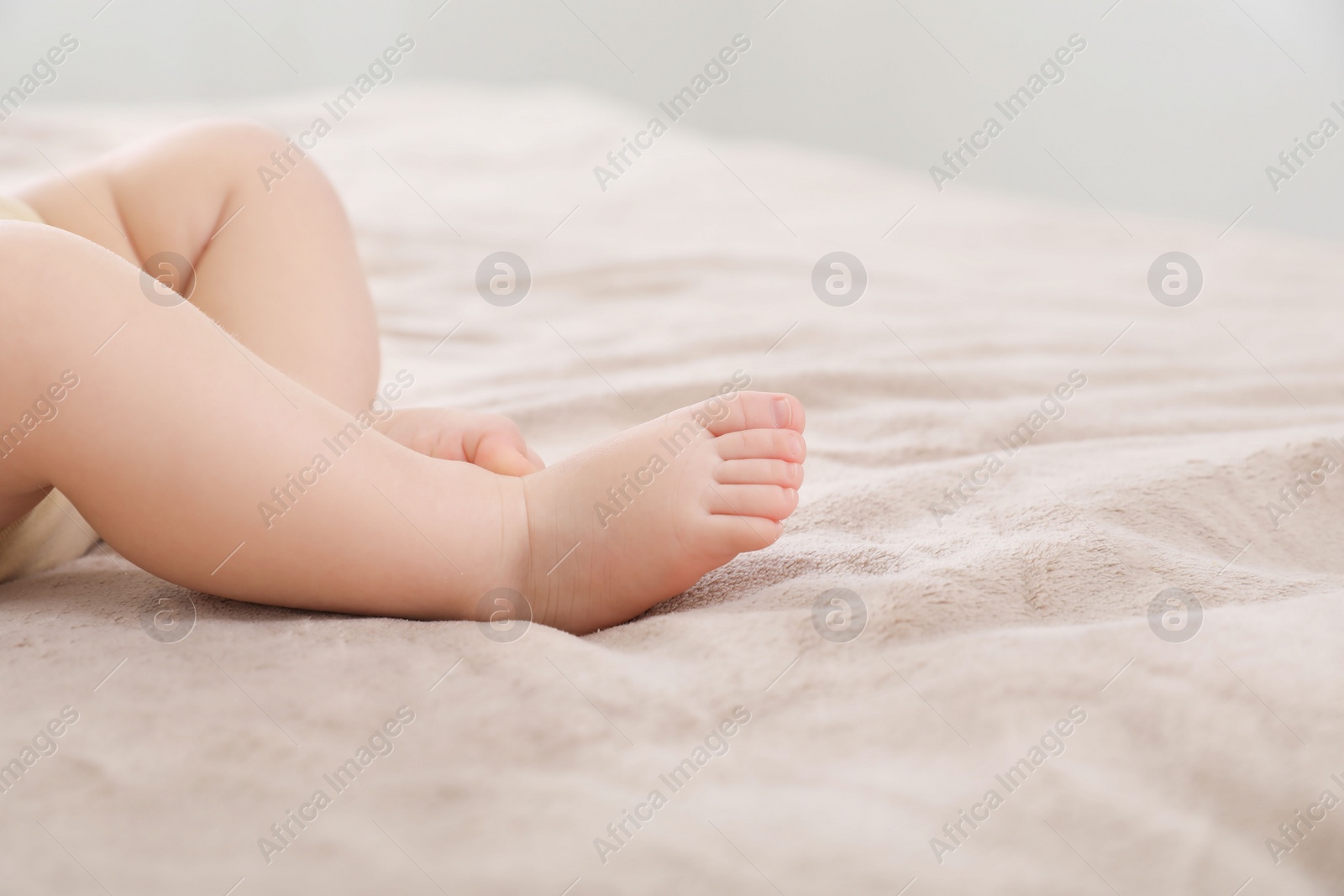 Photo of Little baby on bed, closeup. Space for text