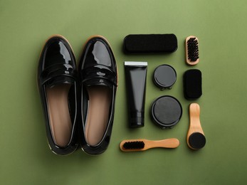 Flat lay composition with shoe care accessories and footwear on green background