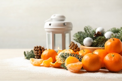 Photo of Christmas composition with fresh tangerines and decorative lantern on white table, space for text